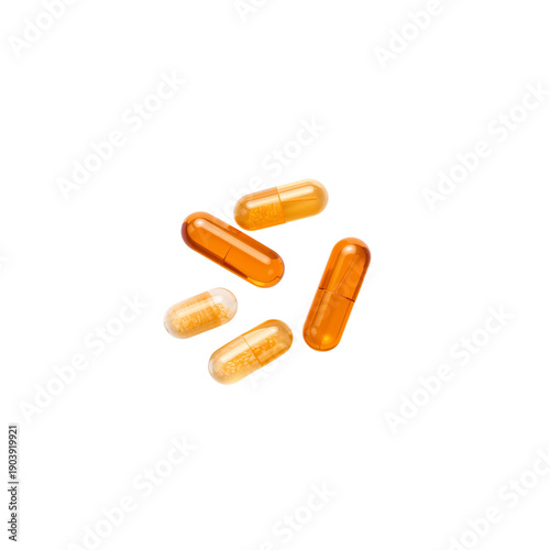 Different Types of Yellow Capsules Placed on White Background at a Close Dist...