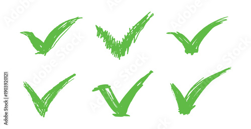 Set of green grunge Check marks, tick, yes, vote brush made symbols or icons. Agree or approving emblem. Hand drawn bold strokes.