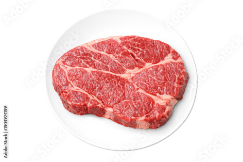 Raw beef chuck eye steak on white plate, fresh red meat cut for grilling or frying, transparent background