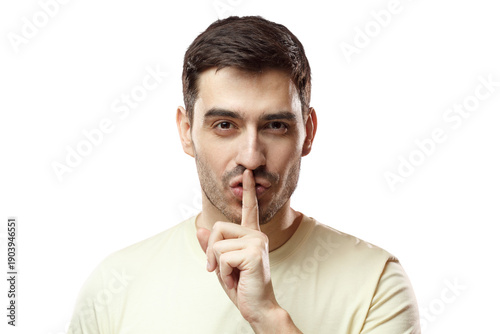 Foto Close up shot of handsome tricky man with shh gesture, asking for silence or to