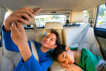 kids riding backseat road trip fun