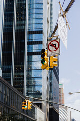 Traffic lights and street signs with glass buildings background