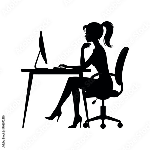 A woman sitting at a desk working on a computer in a thoughtful pose