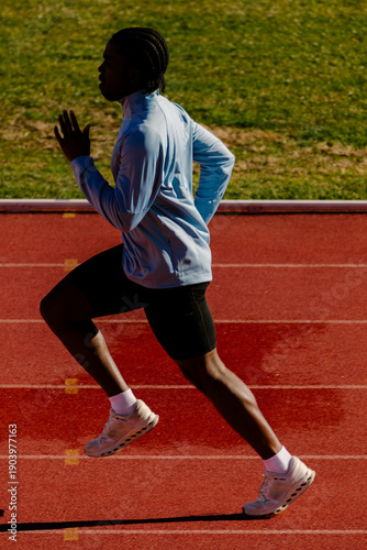 Complete view of a sprinter running at maximum speed along the track