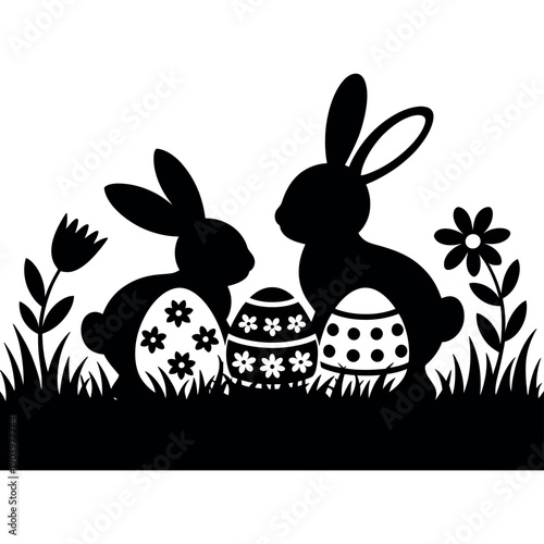 Two Easter bunnies sitting with decorated eggs