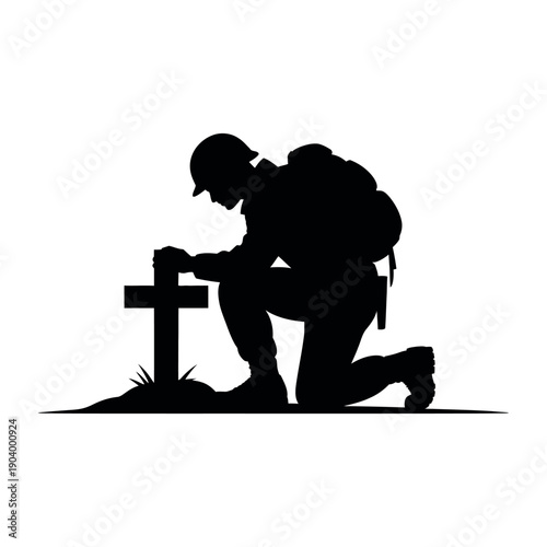 A soldier kneels in respect beside a grave marked with a simple cross