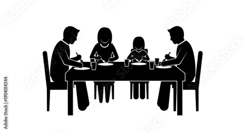 Family of four dining together at a table.