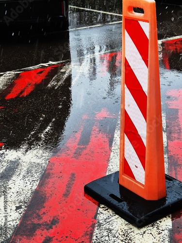 Road cones and wet pavement in a city street