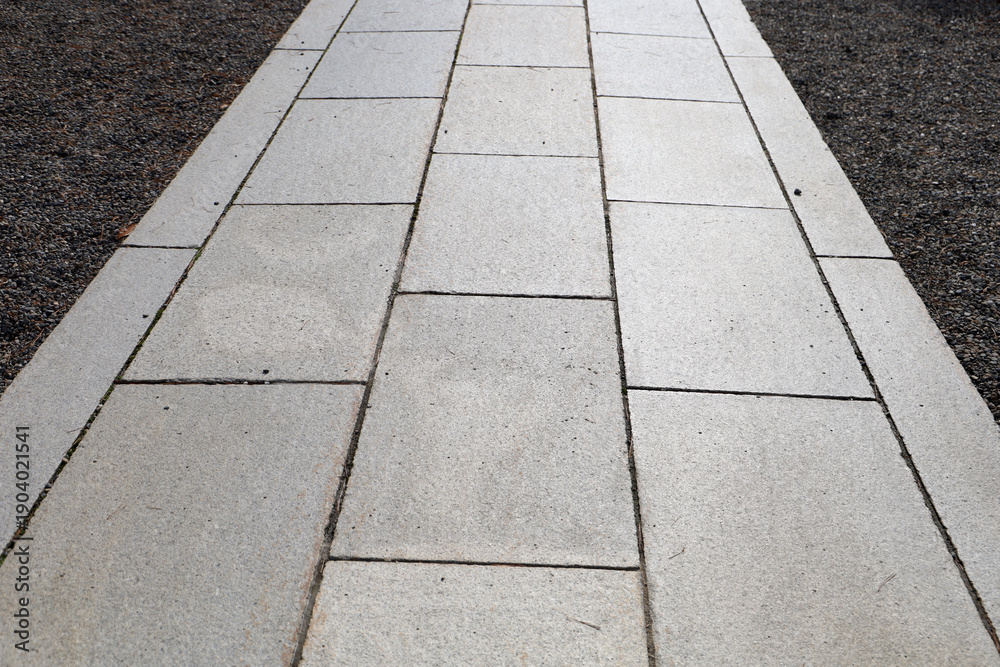 Fototapeta premium Stone curb beside gravel and pavement