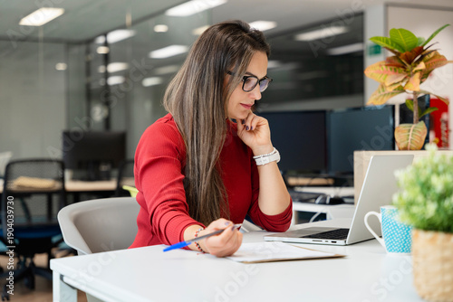 Woman working with laptop in modern office