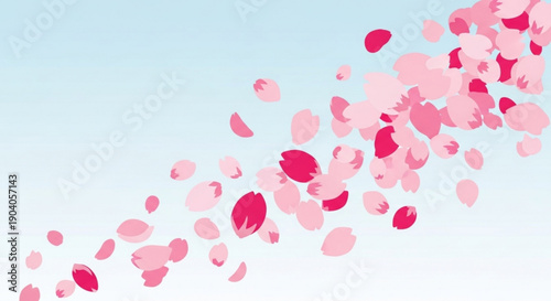 Pink cherry blossom petals floating gently in air against soft blue background