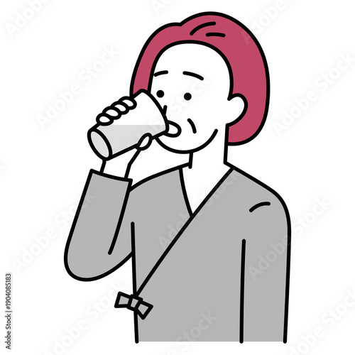 バリウムを飲む検査着の中年の女性