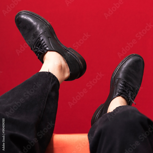 Black Trousers and Shoes on an Orange Chair