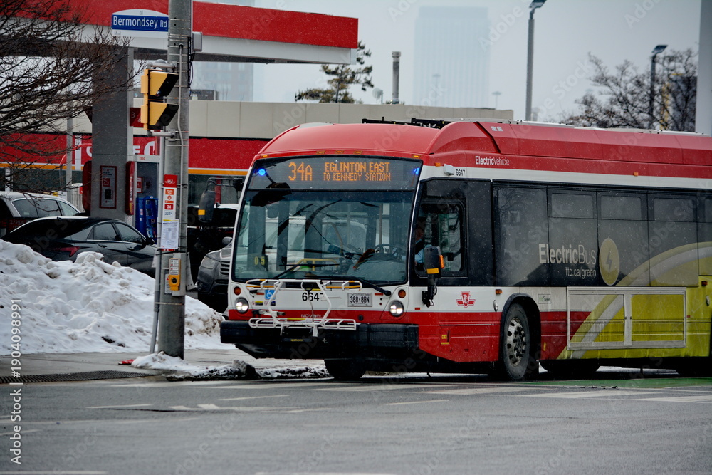 Fototapeta premium Toronto public transport TTC 34 Eglinton East Bus on Eglinton Avenue. Toronto, Ontario, Canada, February 6, 2026: Toronto public transport TTC 34 Eglinton East Bus makes its way along Eglinton Avenue 