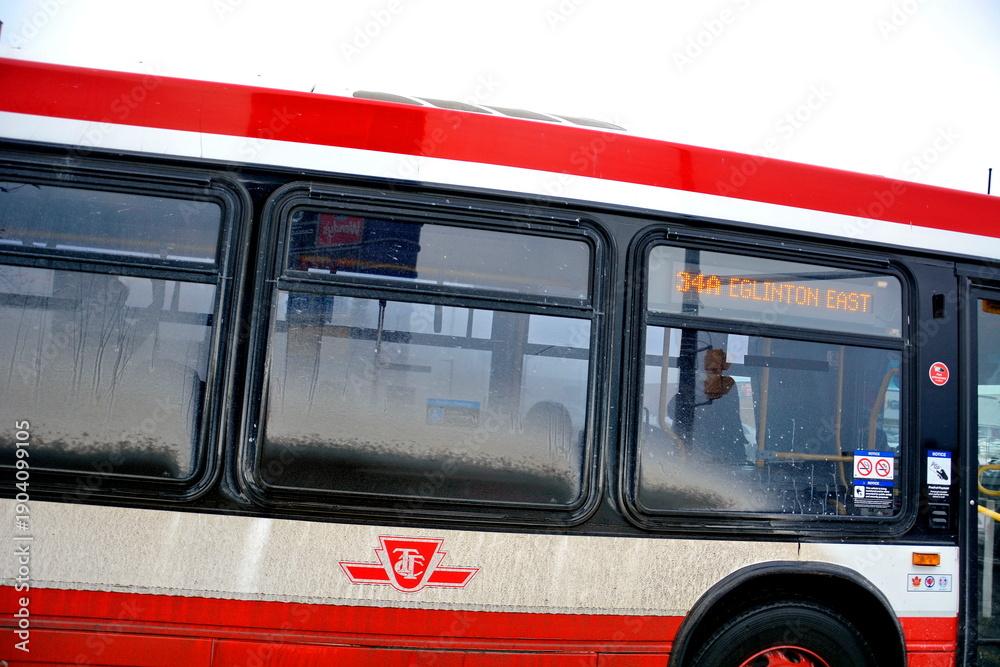 Fototapeta premium Toronto public transport TTC 34 Eglinton East Bus on Eglinton Avenue. Toronto, Ontario, Canada, February 6, 2026: Toronto public transport TTC 34 Eglinton East Bus makes its way along Eglinton Avenue 