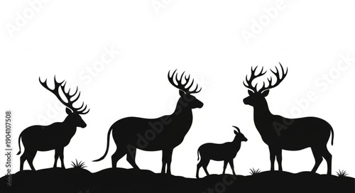 Silhouette of a deer family standing on a hill.