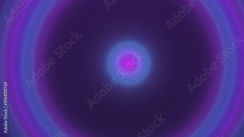 A vibrant circular pattern of purple and blue concentric rings on a dark background