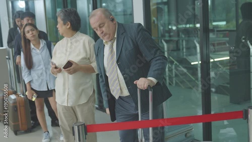 passenger waiting for flight in airport. caucasian businessman was unhappy about the flight delay. man and woman travelers checking time was angry about flight delay