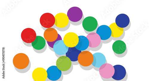 A playful collection of colorful round shapes scattered on a white surface casting soft shadows