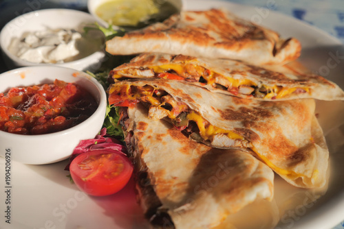 Konstfotografi Delicious quesadilla served with salsa and sour cream