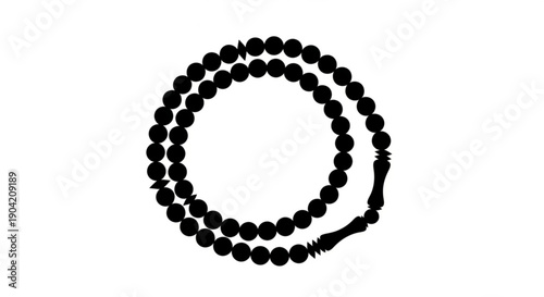 A circular arrangement of black beads on a rosary viewed from above in a simple composition