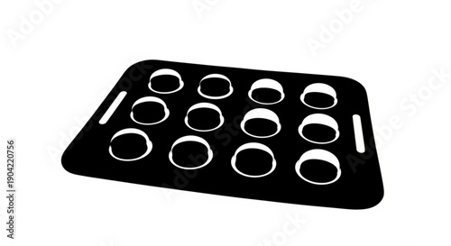 A black muffin tray with twelve circular indentations viewed from above on a white background