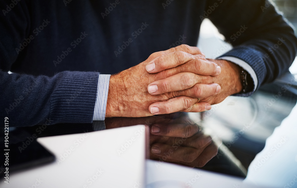 Obraz premium Clasped, paper and hands at desk in office, pension plan or insurance for future financial security. Retirement fund, reliable policy or mature person with annuity contract, calm and wealth assurance