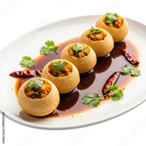 Delicious panipuri dish served on white plate
