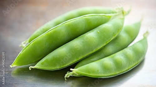 A close up of several plump green pea pods filled with potential for a healthy meal