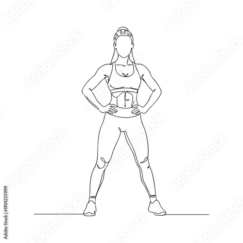 Woman in sportswear standing with hands on hips and legs apart athletic workout exercise