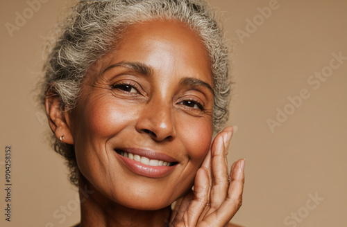 Smiling woman in her fifties with short, curly gray hair, warm expression, and radiant skin in a close-animated movie portrait
