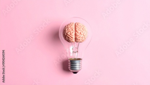 Light bulb with brain inside on pink background, symbolizing ideas and cognition.