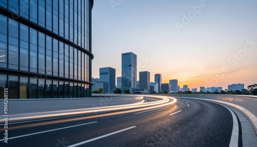 Urban Highway Curving Around Glass Office Buildings at Sunset