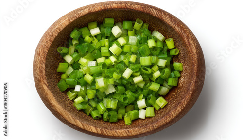 Top view of a round wooden bowl filled with freshly chopped green onions, showing vibrant green color and smooth texture
