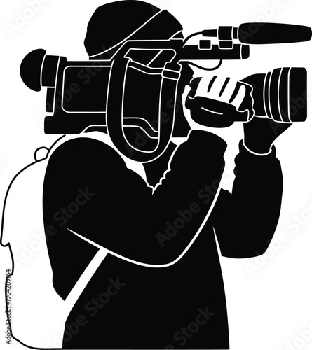 Silhouette of a cameraman filming with a large video camera