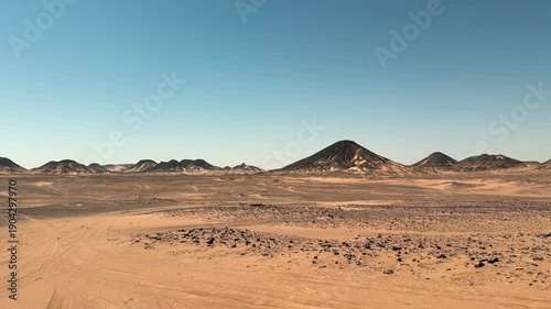Wide panorama of vast Sahara desert plains with distant mountains of White Desert National Park in Egypt