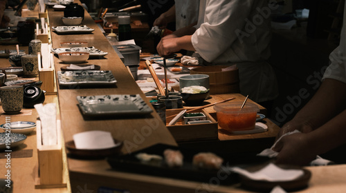 Sushi Chefs Preparing Food at a Traditional Counter Restaurant