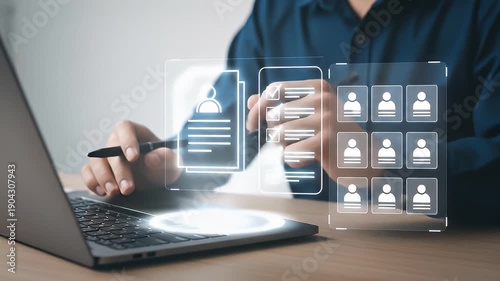 Person using laptop with digital interface showing resumes and profiles.