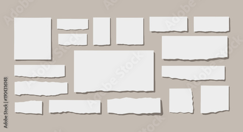 Collection of torn white paper pieces arranged on a neutral beige background