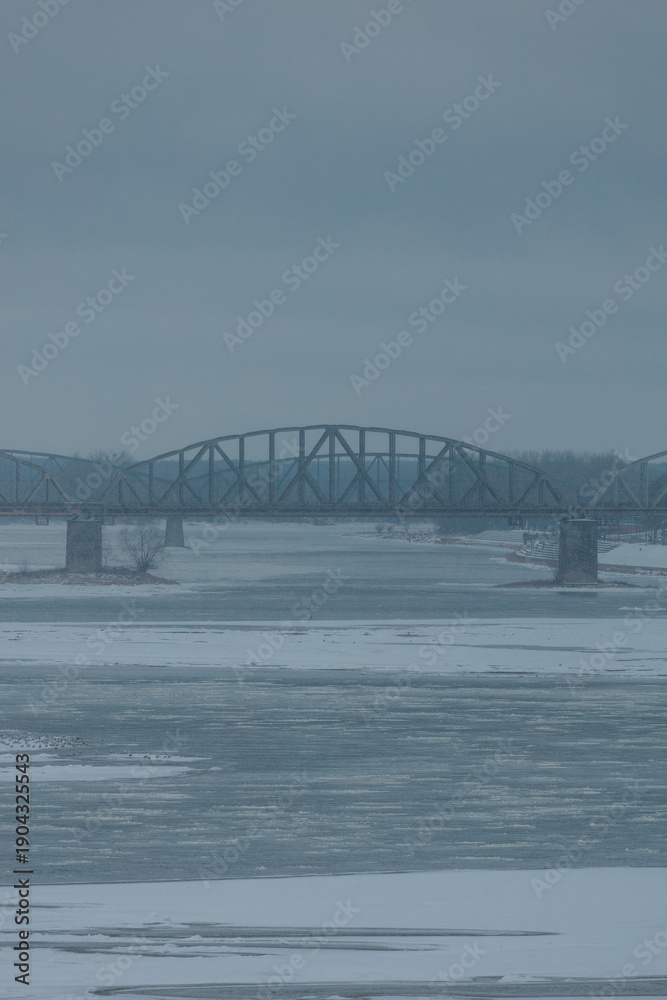 Obraz premium View of the bridges of the city of Toruń and the frozen Vistula River