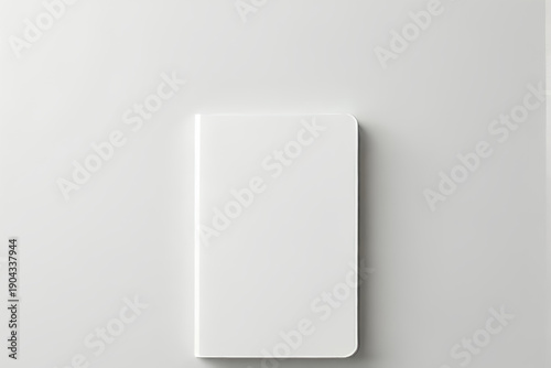 White notebook with rounded corner closed on flat surface minimalist stationery flatlay with soft shadow and subtle texture conveying calm and focus