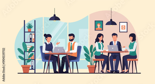 Colleagues collaborating on laptops at desks in a modern office setting