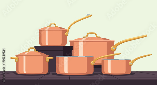 Collection of copper pots and pans with golden handles on a dark surface