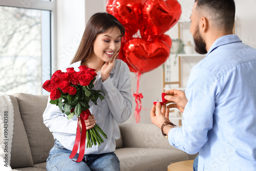 Young man proposing to his ...