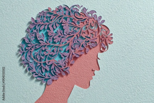 Layered paper craft depicts a woman's profile with elaborate floral hair