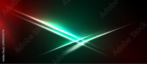 Abstract light streaks intersect. Red, green hues dominate dark background. Brightness creates dynamic visual effect.