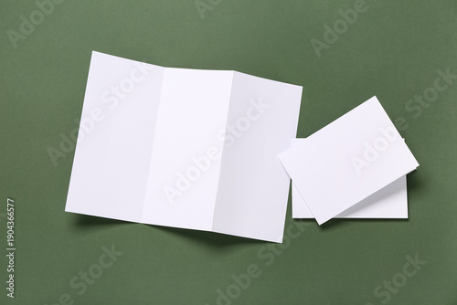 Blank brochures on green ba...