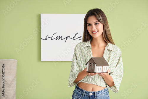 Happy young woman with keys...