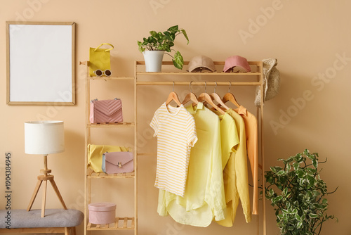 Rack with stylish clothes a...