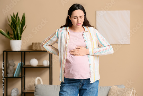 Young pregnant woman suffer...